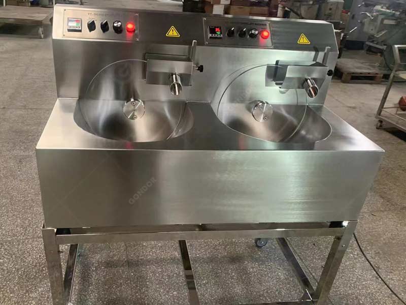 Dual-zone wheel tempering machine for simultaneous tempering of multiple chocolate types