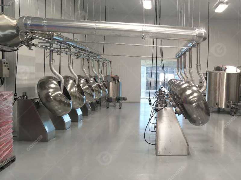 Automated chocolate coating machine in action
