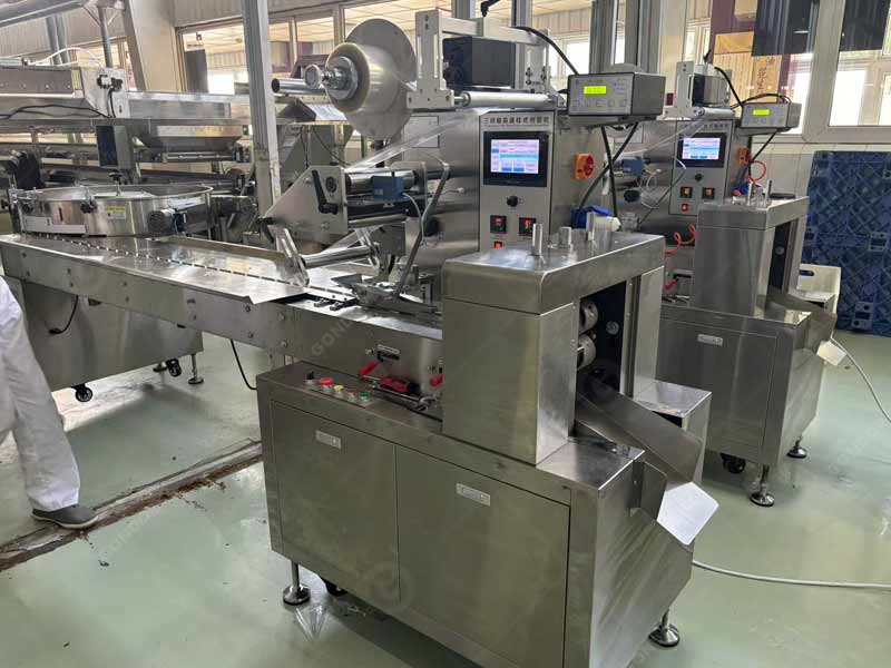 Automatic chocolate bar wrapping machine with film - feeding system